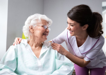 nurse and elderly woman looking at each other