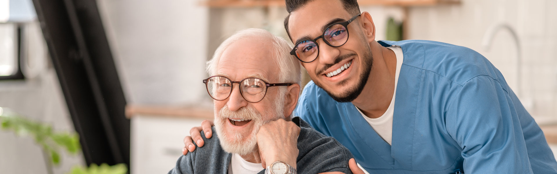 nurse and elderly man looking at the camera