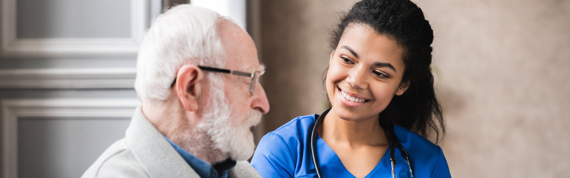 nurse assisting elderly woman