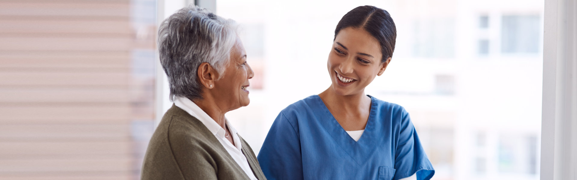 nurse and elderly woman smiling