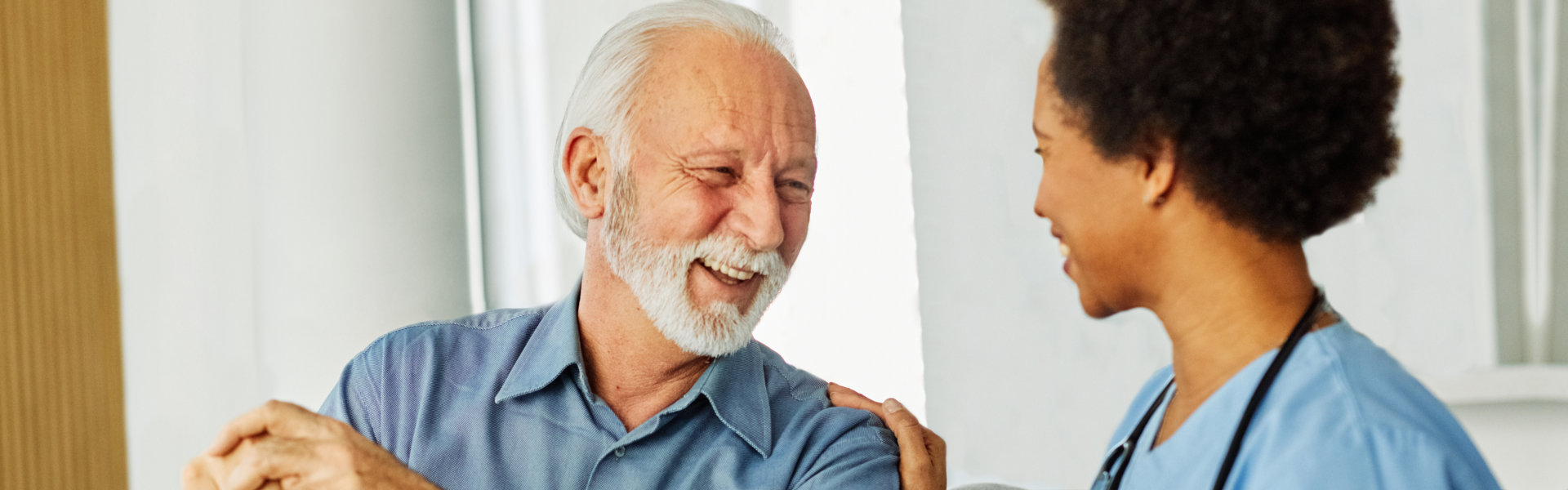 elderly man and nurse talking